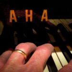 Photo of Yamaha piano with only the 'AHA' showing.